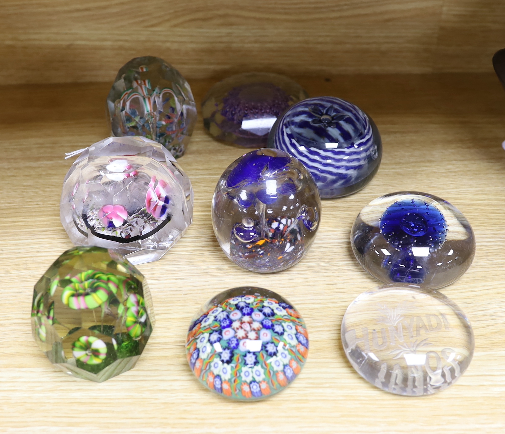 Nine various Bohemian or Hungarian glass paperweights, including for early 20th century Bohemian faceted glass paperweights